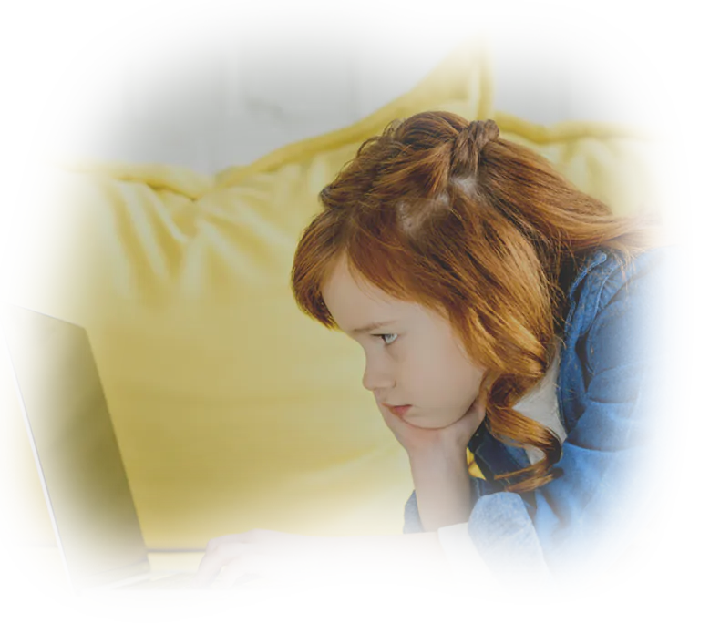 Little redhead girl watching a laptop screen, illustrating the flawless user experience of a high-value digital investment.