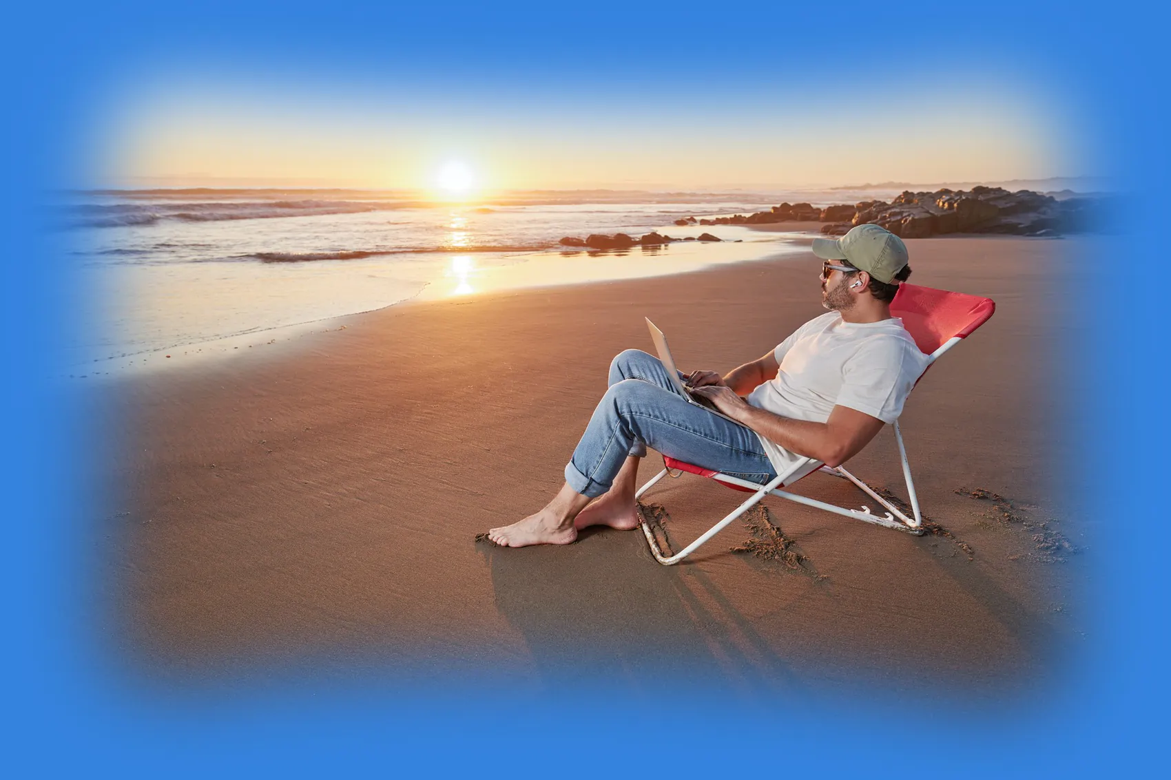 Man with a laptop in a lounge chair on a sandy beach by the ocean during sunset, illustrating absolute business freedom delivered by the ultimate digital employees.
